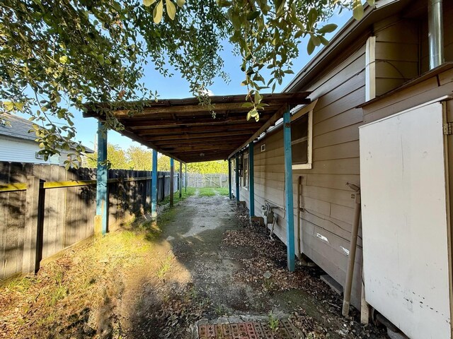 1235 13th St, Street, Port Arthur, TX 77640 - view of patio / terrace with an attached carport and an exterior structure