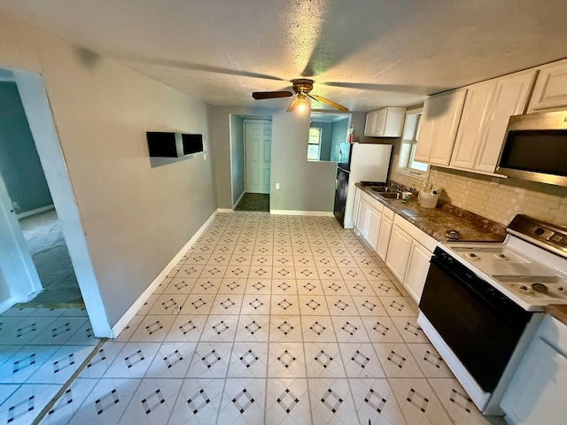 1235 13th St, Street, Port Arthur, TX 77640 - kitchen with white appliances, a ceiling fan, baseboards, backsplash, and white cabinets
