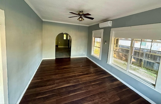 1235 13th St, Street, Port Arthur, TX 77640 - empty room with arched walkways, a ceiling fan, a wall unit AC, dark wood-type flooring, and baseboards