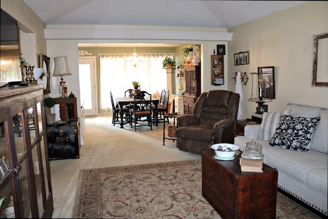 carpeted living room with lofted ceiling and a notable chandelier