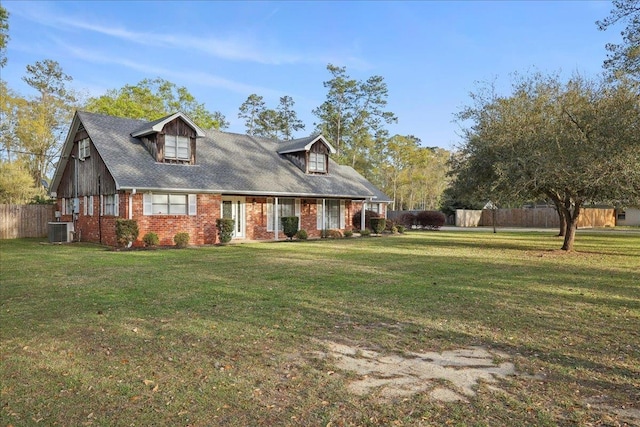 345 Mayhaw Dr, Vidor, TX 77662 - cape cod-style house with cooling unit, brick siding, a front yard, and fence