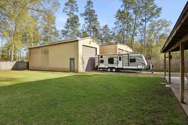345 Mayhaw Dr, Vidor, TX 77662 - view of yard featuring an outbuilding, fence, and a garage
