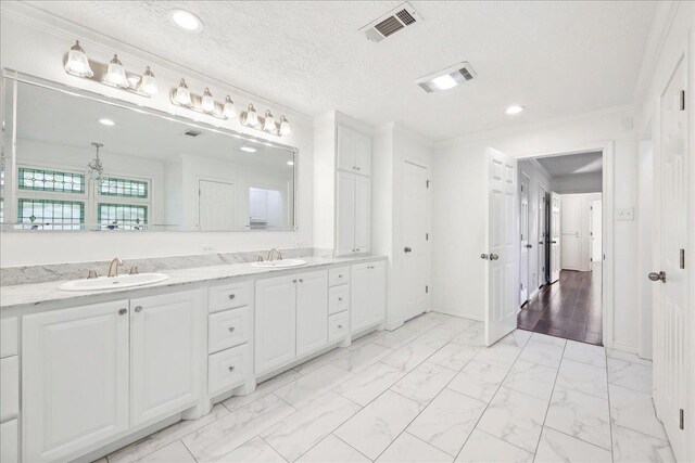 345 Mayhaw Dr, Vidor, TX 77662 - full bathroom featuring marble finish floor, visible vents, a sink, and crown molding