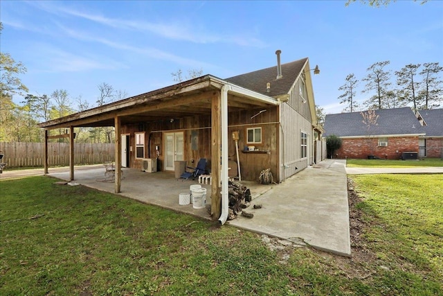 345 Mayhaw Dr, Vidor, TX 77662 - rear view of house featuring a yard, fence, and a patio