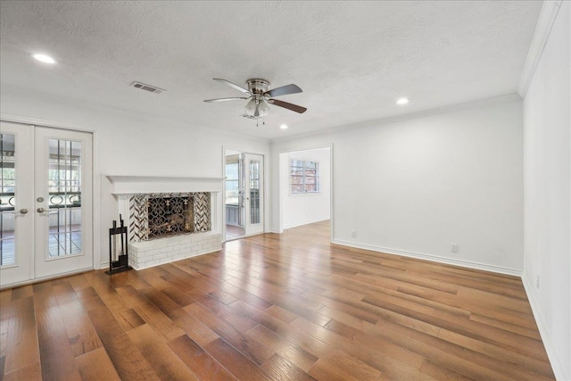 345 Mayhaw Dr, Vidor, TX 77662 - unfurnished living room with visible vents, a ceiling fan, french doors, and hardwood / wood-style floors