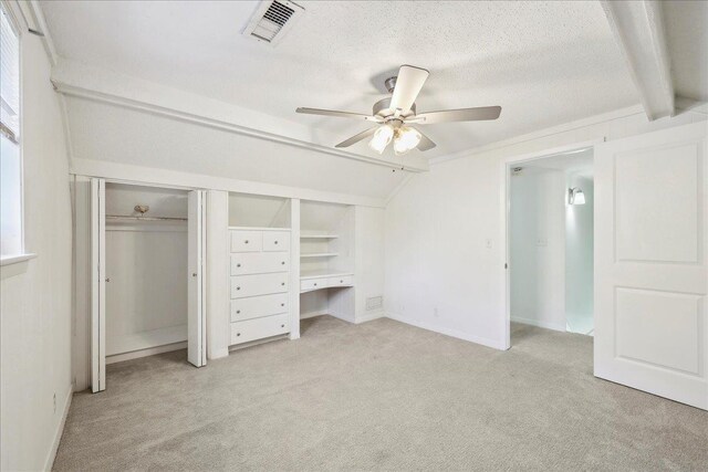 345 Mayhaw Dr, Vidor, TX 77662 - unfurnished bedroom with a ceiling fan, vaulted ceiling with beams, a textured ceiling, light colored carpet, and visible vents