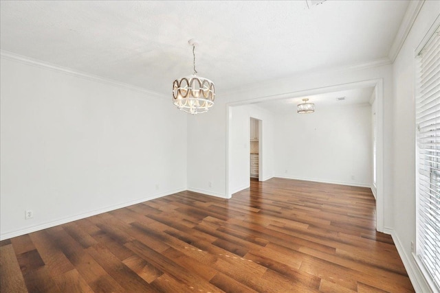 345 Mayhaw Dr, Vidor, TX 77662 - unfurnished room featuring a notable chandelier, crown molding, baseboards, and wood finished floors