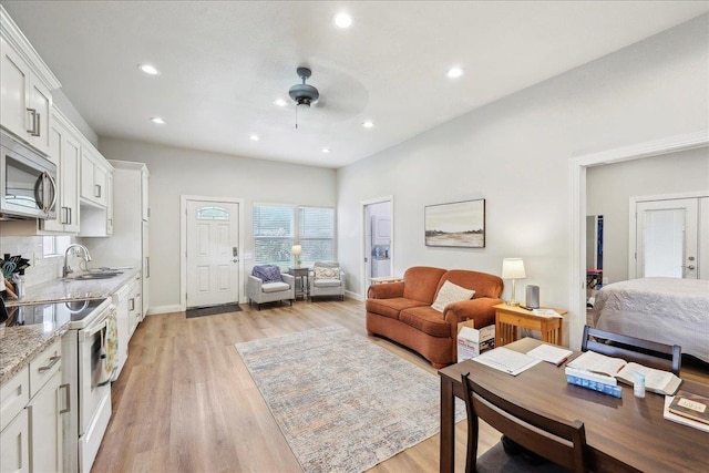 345 Mayhaw Dr, Vidor, TX 77662 - living area with a ceiling fan, light wood-style flooring, baseboards, and recessed lighting