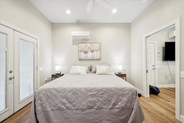 345 Mayhaw Dr, Vidor, TX 77662 - bedroom featuring wood finished floors, a wall mounted air conditioner, ensuite bath, baseboards, and recessed lighting