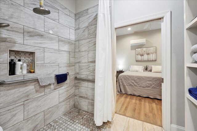 345 Mayhaw Dr, Vidor, TX 77662 - ensuite bathroom with a tile shower, an AC wall unit, and ensuite bath