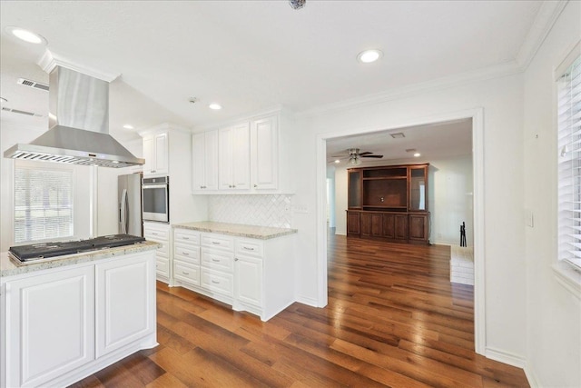 345 Mayhaw Dr, Vidor, TX 77662 - kitchen with white cabinets, ornamental molding, appliances with stainless steel finishes, extractor fan, and dark wood-style floors
