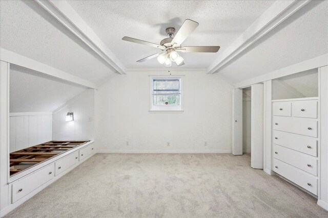 345 Mayhaw Dr, Vidor, TX 77662 - unfurnished bedroom with vaulted ceiling with beams, carpet flooring, and a textured ceiling