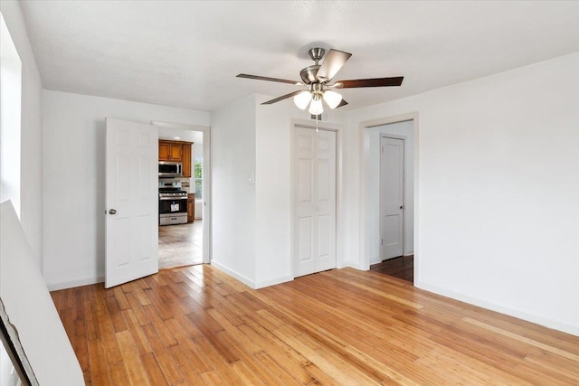 spare room with ceiling fan and light hardwood / wood-style floors