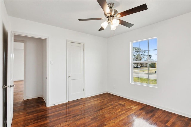 unfurnished bedroom featuring ceiling fan and dark hardwood / wood-style flooring