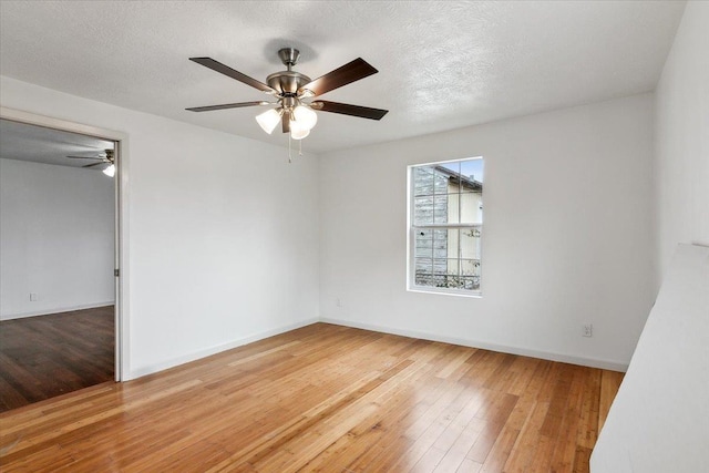 empty room featuring a textured ceiling and wood-type flooring