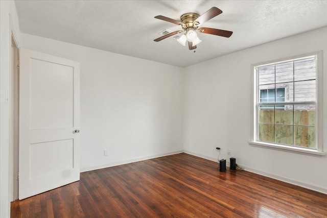 unfurnished room featuring ceiling fan, dark hardwood / wood-style floors, and a textured ceiling