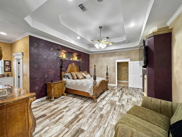 2460 W Norman Cir, Orange, TX 77630 - bedroom with a tray ceiling, wood finished floors, ornamental molding, baseboards, and recessed lighting