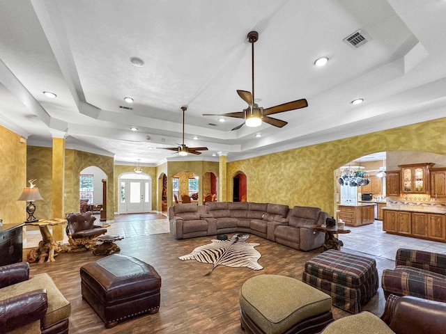 2460 W Norman Cir, Orange, TX 77630 - living room featuring arched walkways, a tray ceiling, a ceiling fan, recessed lighting, and wallpapered walls