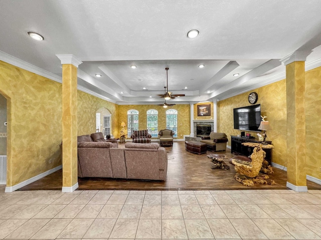2460 W Norman Cir, Orange, TX 77630 - tiled living area featuring ceiling fan, a raised ceiling, baseboards, ornamental molding, and ornate columns