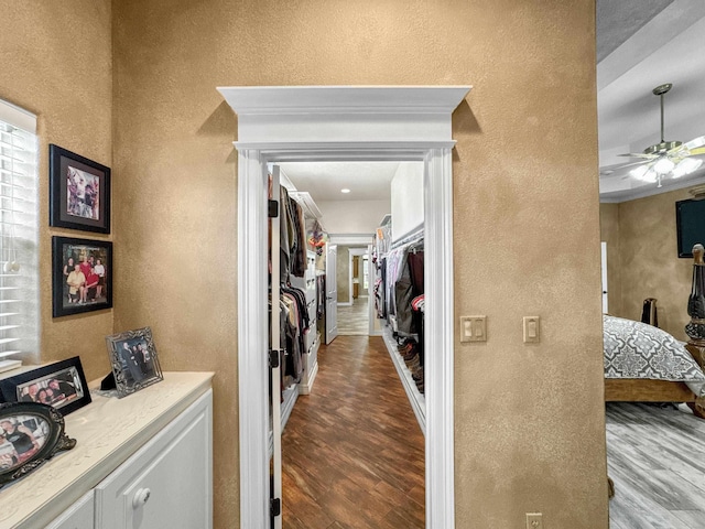 2460 W Norman Cir, Orange, TX 77630 - corridor with a textured wall and wood finished floors