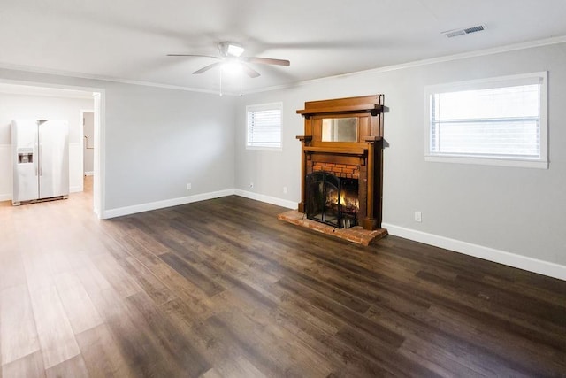 unfurnished living room with crown molding, dark wood-type flooring, and ceiling fan