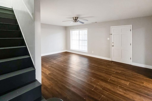 unfurnished living room featuring ceiling fan and dark hardwood / wood-style floors