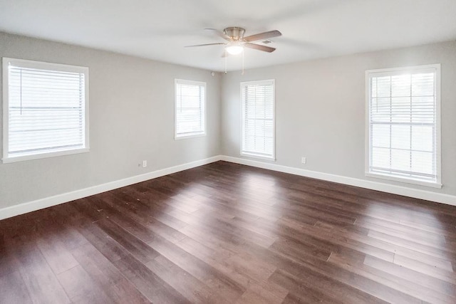 spare room featuring ceiling fan and dark wood-type flooring