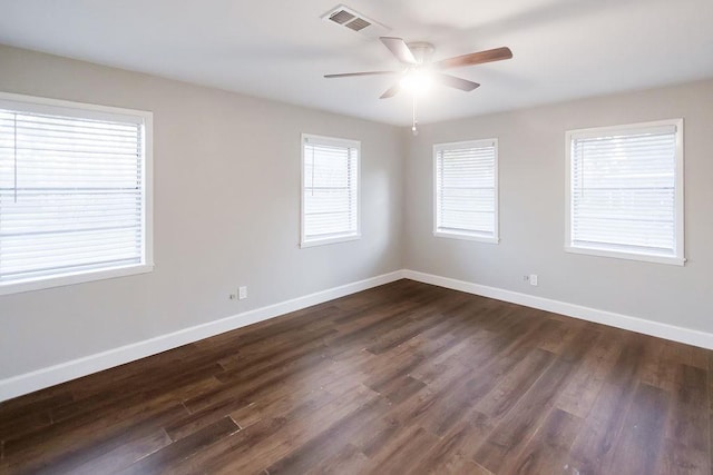 unfurnished room featuring dark wood-type flooring and ceiling fan