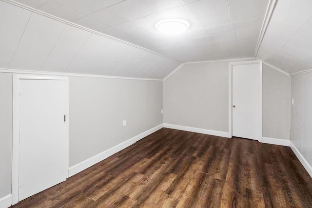 bonus room featuring dark hardwood / wood-style floors and vaulted ceiling