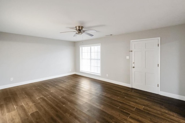 spare room featuring ceiling fan and dark hardwood / wood-style floors