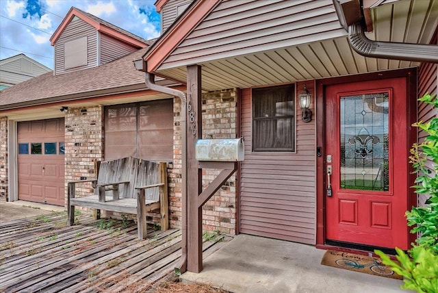 view of exterior entry with a garage