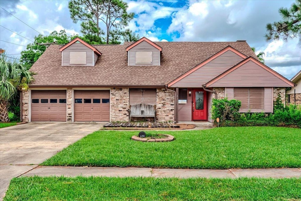 view of front of property featuring a garage and a front lawn