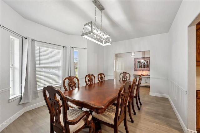 dining area with light wood-style flooring and baseboards