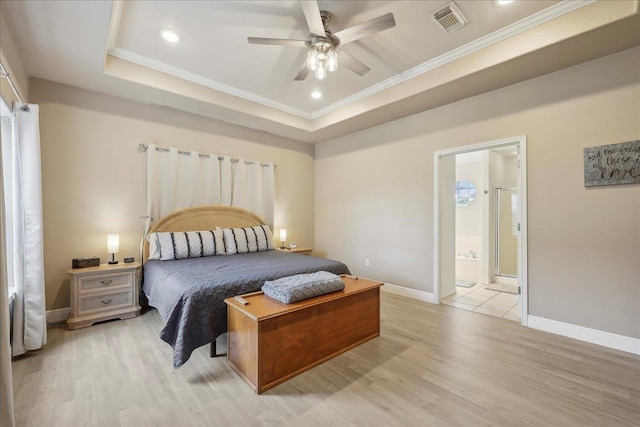 bedroom with crown molding, a raised ceiling, visible vents, light wood-style flooring, and baseboards