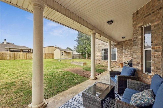 view of patio / terrace featuring a fenced backyard, an outdoor structure, an outdoor hangout area, and a shed