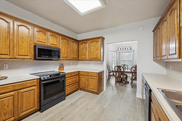 kitchen with black range with electric stovetop, a sink, light wood-type flooring, dishwasher, and brown cabinetry