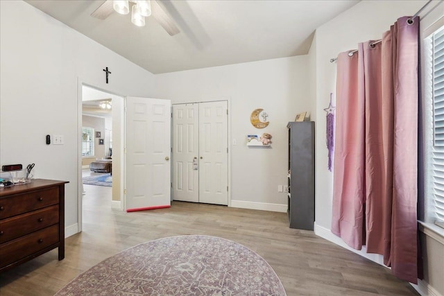 bathroom featuring ceiling fan, baseboards, and wood finished floors