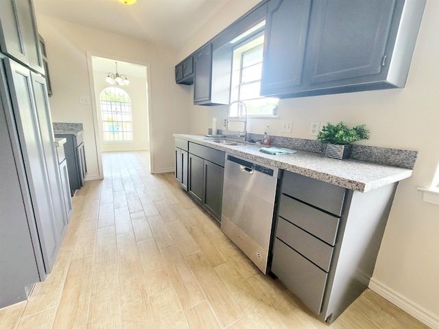 4410 Fortune Ln, Beaumont, TX 77705 - kitchen with dishwasher, light wood-style flooring, a chandelier, light countertops, and a sink