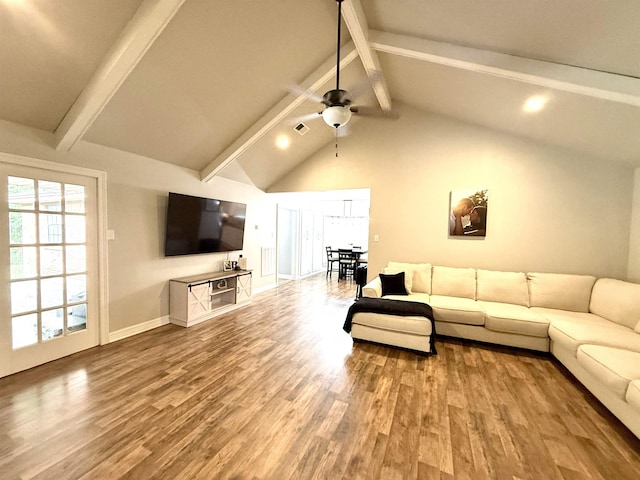 living area with baseboards, a ceiling fan, beam ceiling, and wood finished floors