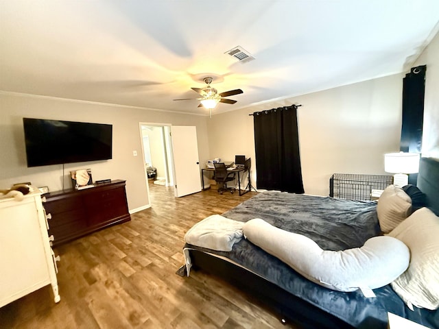 bedroom featuring baseboards, ceiling fan, wood finished floors, and visible vents