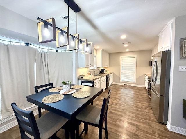 dining room with recessed lighting, baseboards, visible vents, and dark wood finished floors