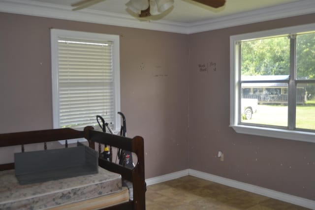 bedroom with ceiling fan and ornamental molding