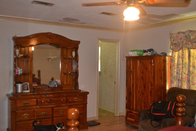 living area with light hardwood / wood-style floors, ceiling fan, and crown molding