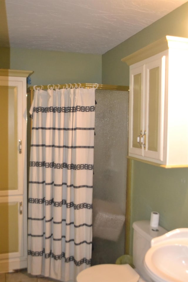 bathroom with sink, toilet, tile patterned flooring, and a shower with shower curtain