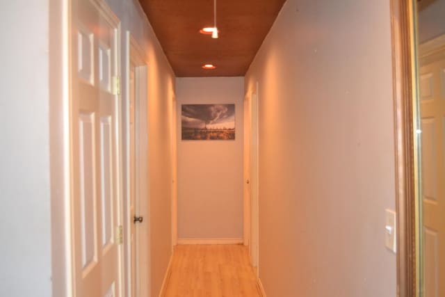 corridor with light hardwood / wood-style flooring