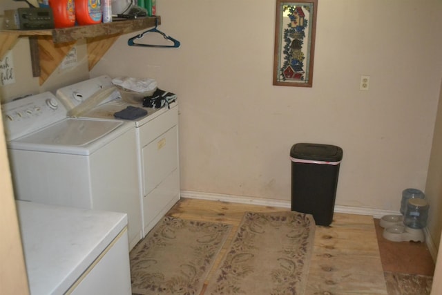 washroom featuring light hardwood / wood-style flooring and washer and dryer