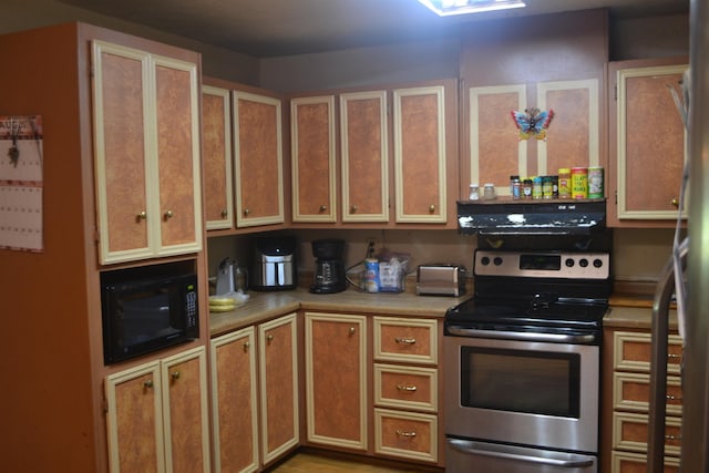 kitchen with black microwave and stainless steel range with electric cooktop