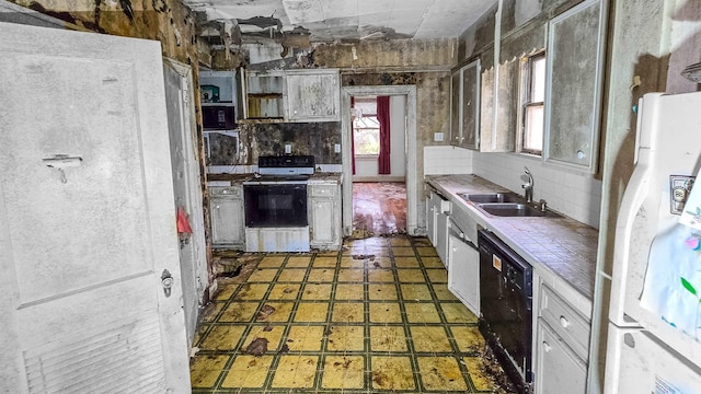 kitchen with white appliances, tile counters, sink, and backsplash