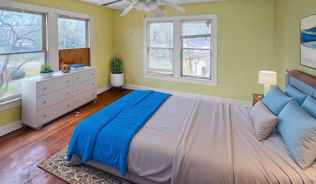 bedroom featuring multiple windows and hardwood / wood-style floors