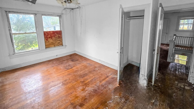 unfurnished bedroom with wood-type flooring and a closet